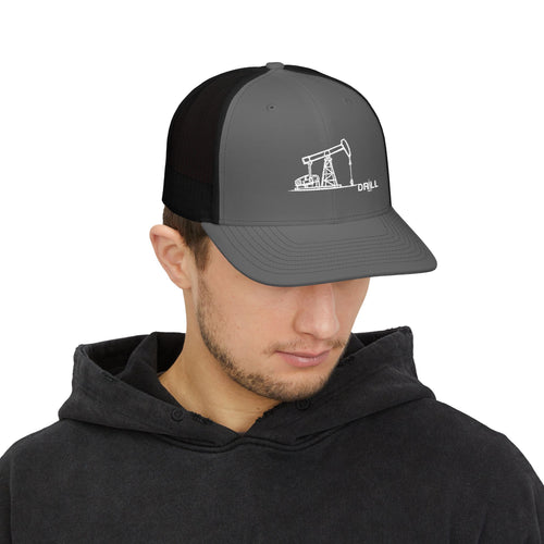 Man wearing a black and gray cap with a drilling rig design on a white background